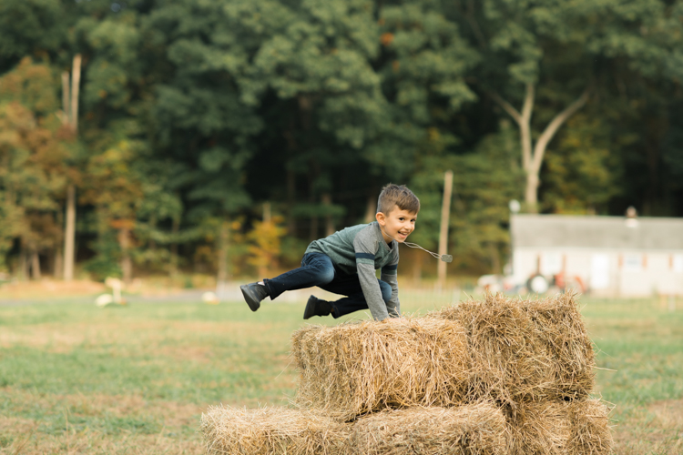 Fall is in full swing here in NJ, my first Fall Family session with Anna and Adam at their Farm House in Hackettstown NJ. Anna and Adam recently purchased their dream farm house on a 4 acres of land. This family of four now has chickens, ducks, birds, cats, a dog, sheep and plans to add many more to the list in the future. I had the honor of visiting Anna and Adam and their two beautiful children at their Farm the other day. I got much need vitamin D walking around the property, enjoying the foliage, running around with their kids and meeting all the farm animals. I sincerely enjoy photographing families now because there are no dull moments with kids, every moment is perfect! Fall family session at Anna and Adam’s Farm at Hackettstown NJ photographed by Karis from HeyKaris.